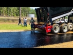 Tailgate chip spreader Amerispreader shown at work dropping stone chips Quachita County Arkansas roadway