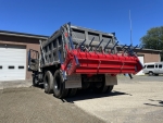 chip spreader Ameripatcher by PavementGroup shown with dump truck body fully down