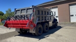 gravity spreader Amerispreader shown attached to back of dump truck 