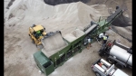 industrial pugmill system, shown from above loading two different aggregates into  2 stone bins with electronic gate controls, asphalt pump and folding discharge conveyor