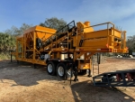 Olympus 2 bin pugmill system shown with conveyor discharge, onboard generator, vibrators and weigh pridge